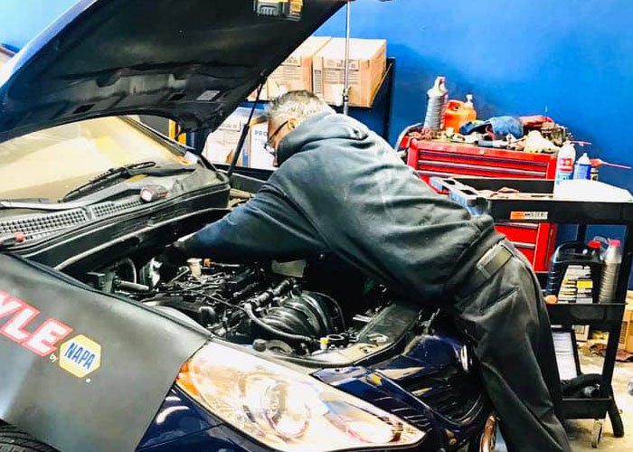 Auto Repair Techician working on a car